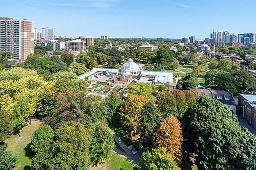 Allan Gardens conservatory and green park seen from Jarvis Street