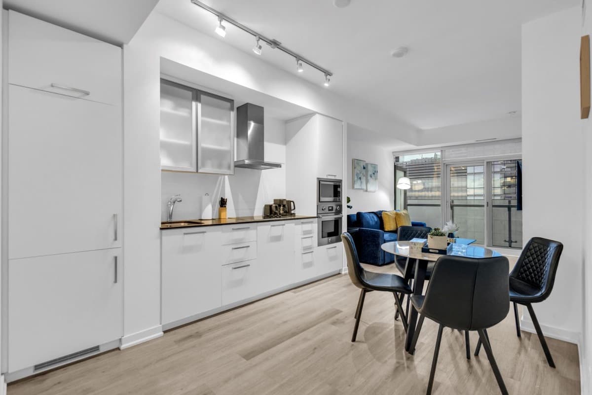 Kitchen, dining table and living area in a real StayToronto York furnished suite in South Core