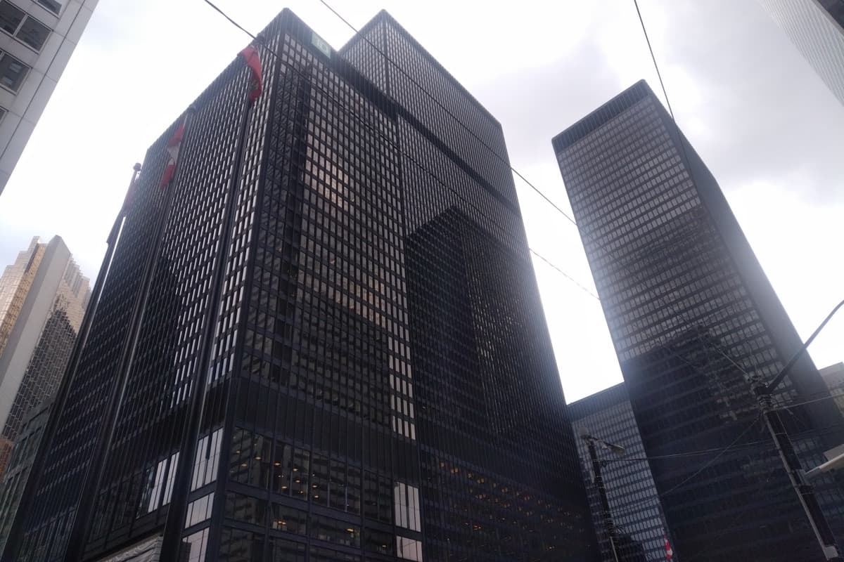 Dark office towers rising above the street in Toronto Financial District