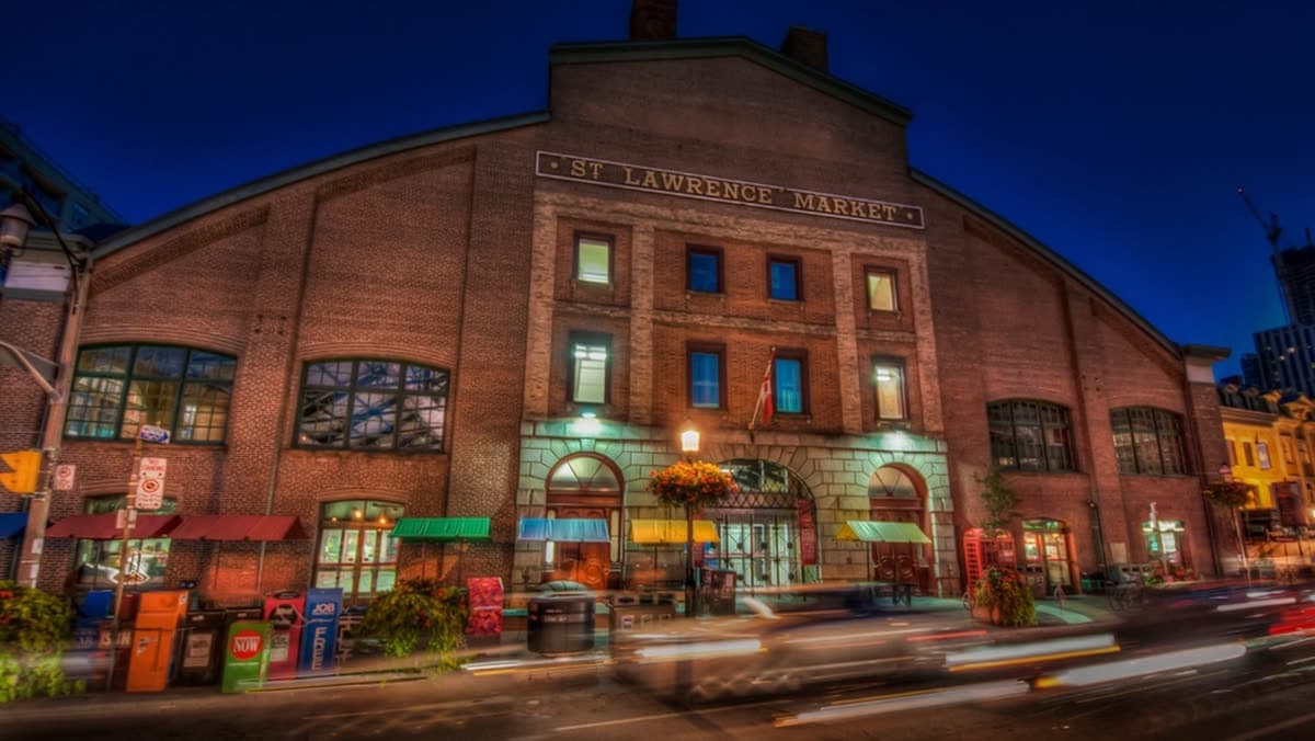 St. Lawrence Market brick exterior illuminated at dusk in downtown Toronto