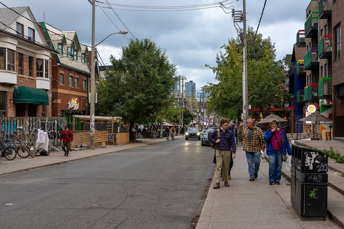 Pedestrians and storefronts on Augusta Avenue in Kensington Market, Toronto