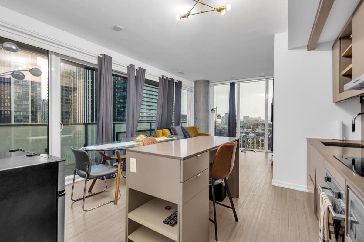 Kitchen, dining area and living room in a real StayToronto Peter two-bedroom suite