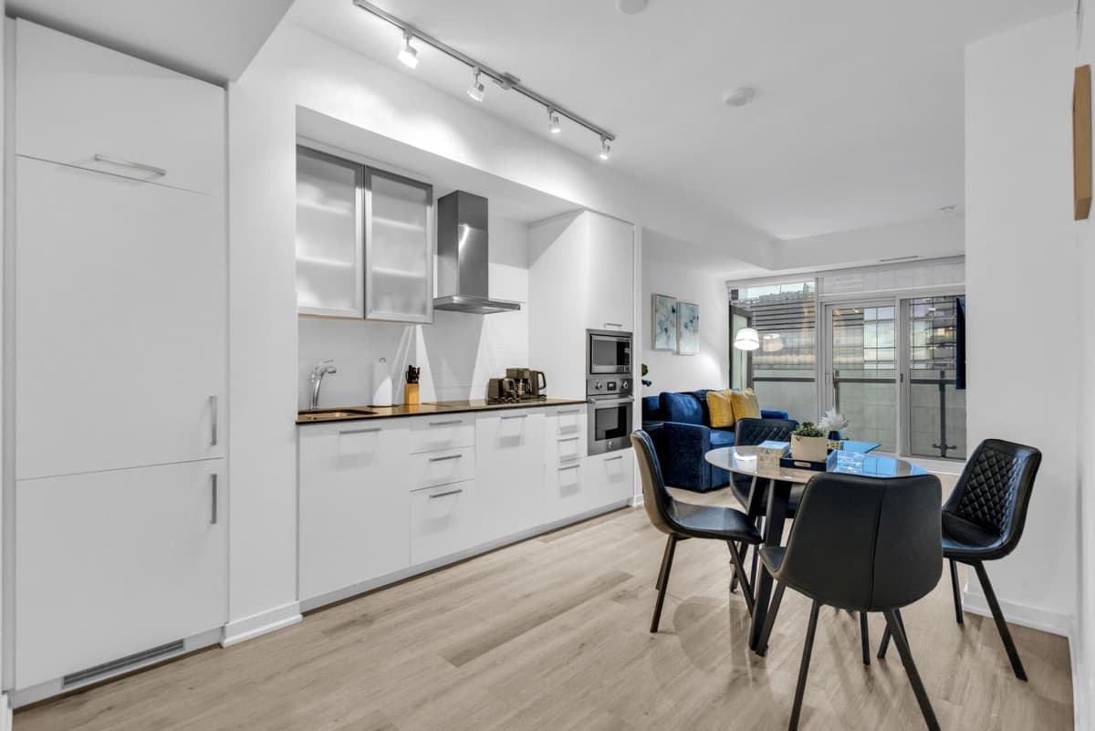 Full kitchen, dining table and living area in a real StayToronto York furnished suite in South Core