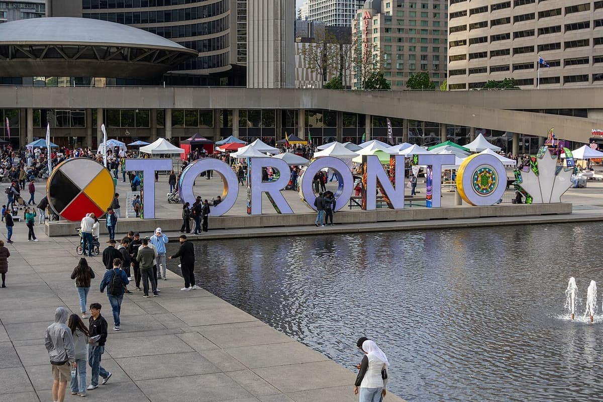 The colourful TORONTO Sign and reflecting pool at Nathan Phillips Square