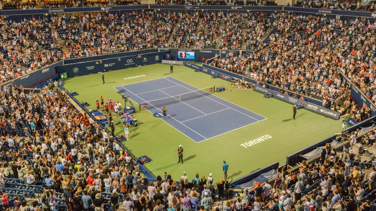 Blue tennis court and tiered seating at Toronto's summer tennis stadium