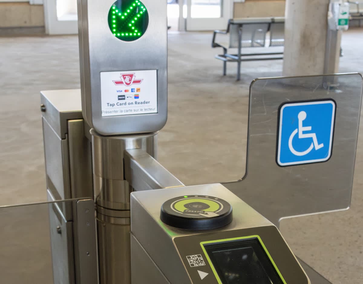 Close view of the top and side PRESTO readers on a TTC fare gate at Leslie Station