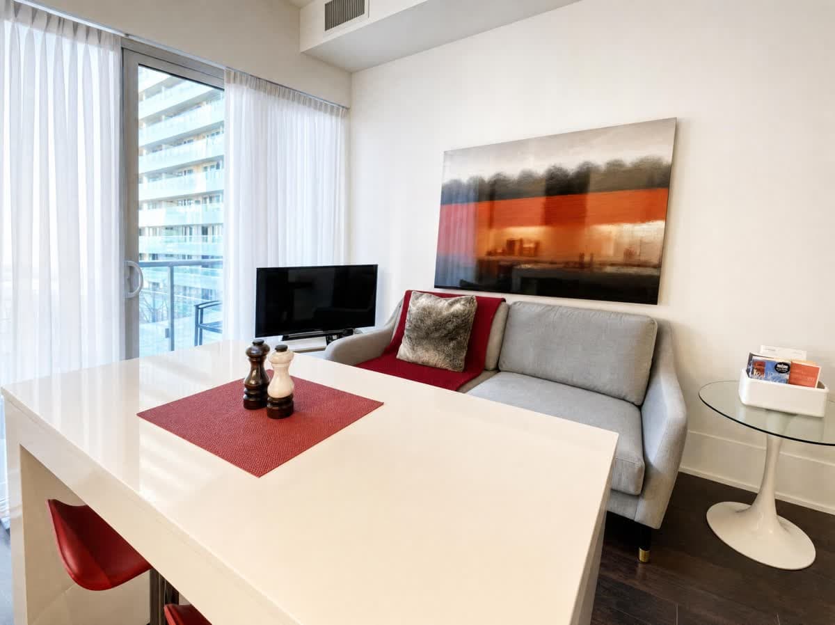 Living and dining area in a real Atmos one-bedroom furnished suite in Toronto's Entertainment District