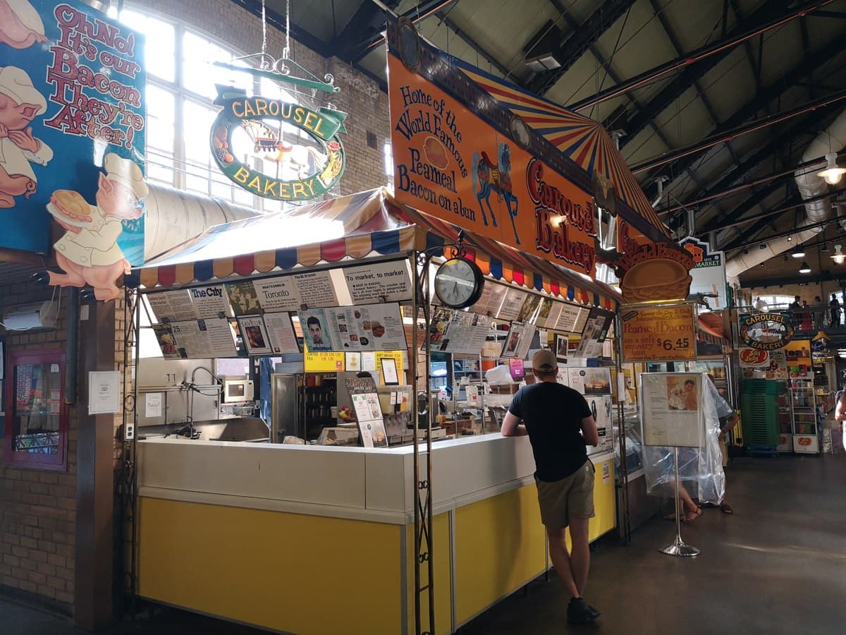 Carousel Bakery counter and hanging signs inside St Lawrence Market, Toronto