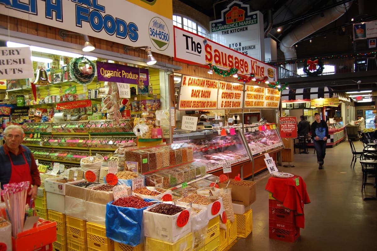 Food stalls and signs inside St. Lawrence Market in downtown Toronto
