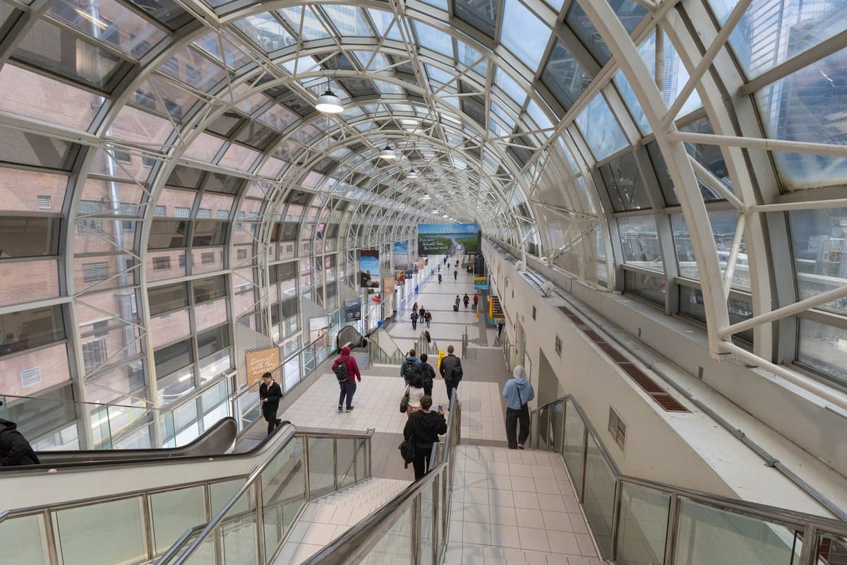 Glass roof, white steel arches, stairs and escalators inside Toronto's Union Station SkyWalk