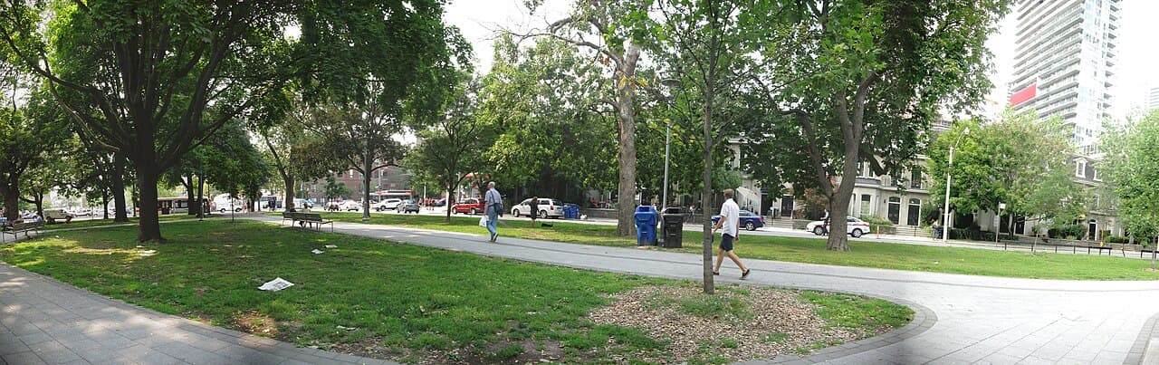 Trees, lawn and paths in Clarence Square beside Wellington Street West